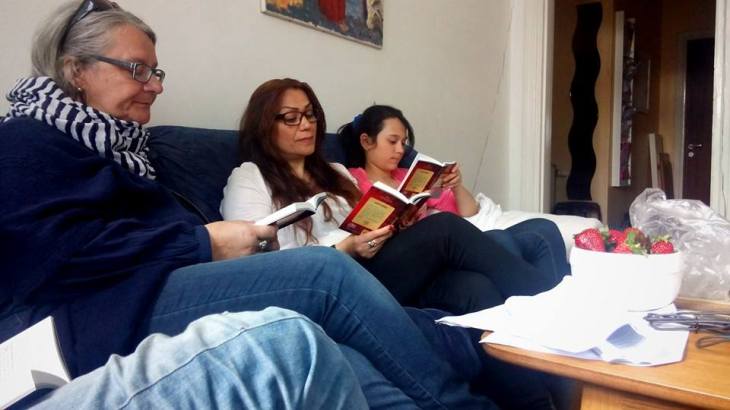 My pastor Lotta (left) reads the Bible with some new visitors at a Sunday meeting in our house church Mosaik
